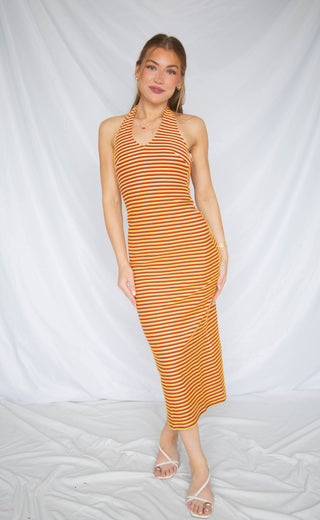 Woman wearing a striped dress against a white background