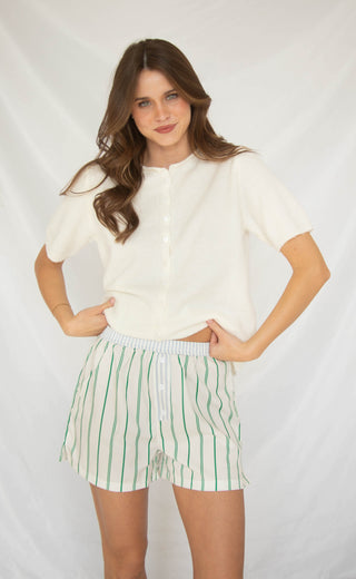 Women wearing green and blue striped boxer shorts. 