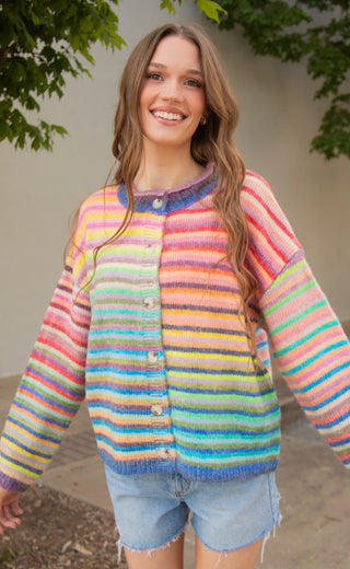 Woman wearing a colorful striped sweater outdoors