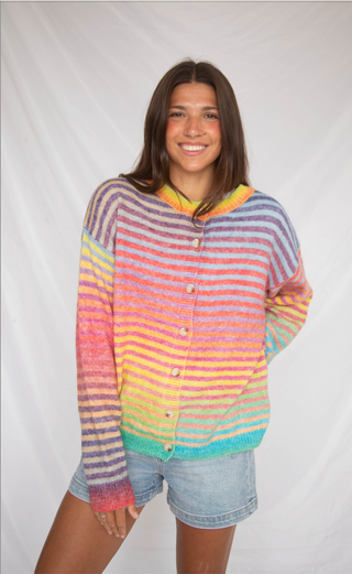 Person wearing a colorful striped sweater against a white background
